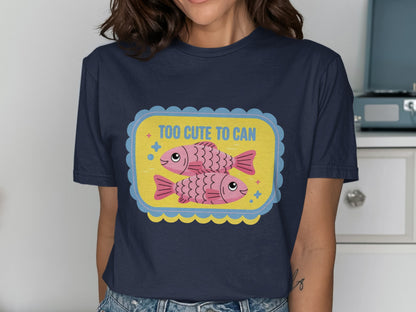 Navy t-shirt with a graphic of two pink fish and text that says "TOO CUTE TO CAN".