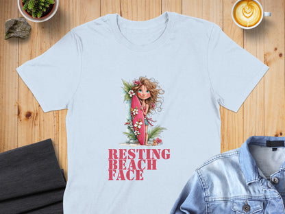 Light blue t-shirt with "RESTING BEACH FACE" text and girl with surfboard graphic.