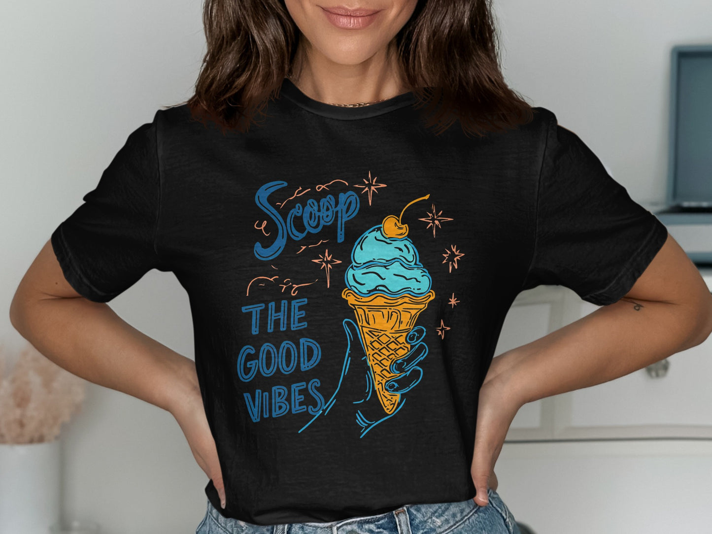 Black t-shirt with blue ice cream cone and text "Scoop the good vibes".