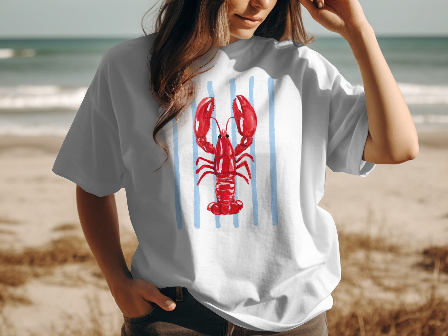 White t-shirt with a watercolor lobster illustration on blue stripes.