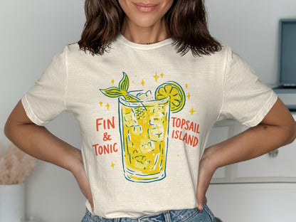Cream t-shirt with graphic of a Fin & Tonic cocktail and lemon slice.