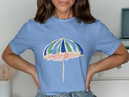 Blue t-shirt with a colorful striped umbrella graphic.