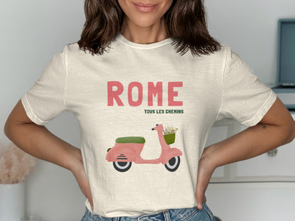 Cream t-shirt with pink scooter graphic and "Rome Tous Les Chemins" text.