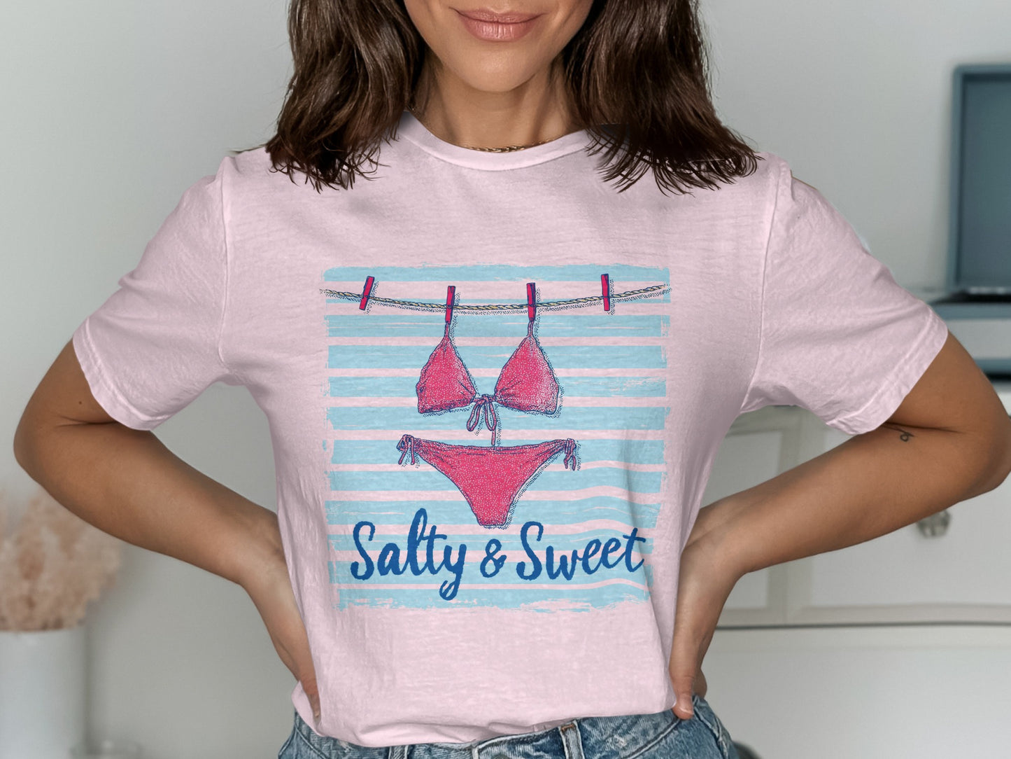 Pink bikini on clothesline with "Salty & Sweet" text.