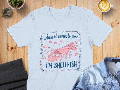 Light blue t-shirt with pink lobster and text "when it comes to you I'M SHELLFISH".