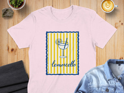 Pink t-shirt with a limoncello glass graphic and blue and yellow striped border.