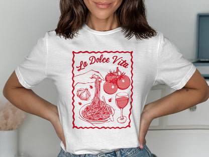White t-shirt with red "La Dolce Vita" graphic featuring spaghetti, tomatoes, and wine.