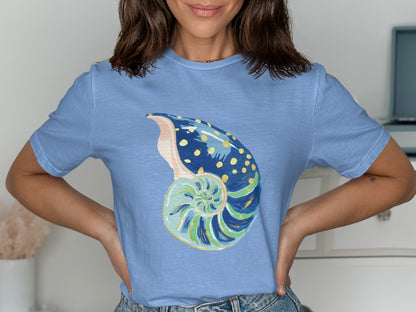 Blue t-shirt with a stylized, colorful nautilus shell graphic.