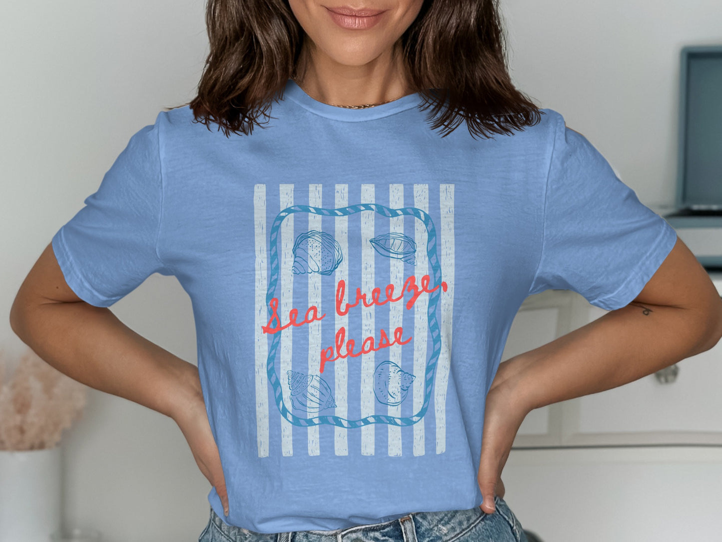 Light blue t-shirt with "Sea breeze, please" and seashell design.
