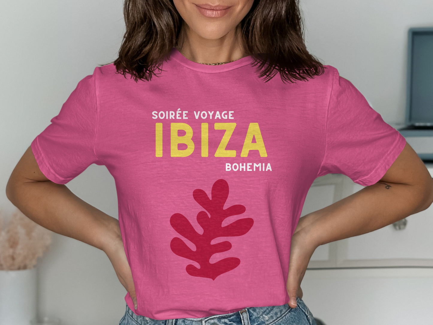 Pink t-shirt with yellow "IBIZA" and red abstract leaf graphic.