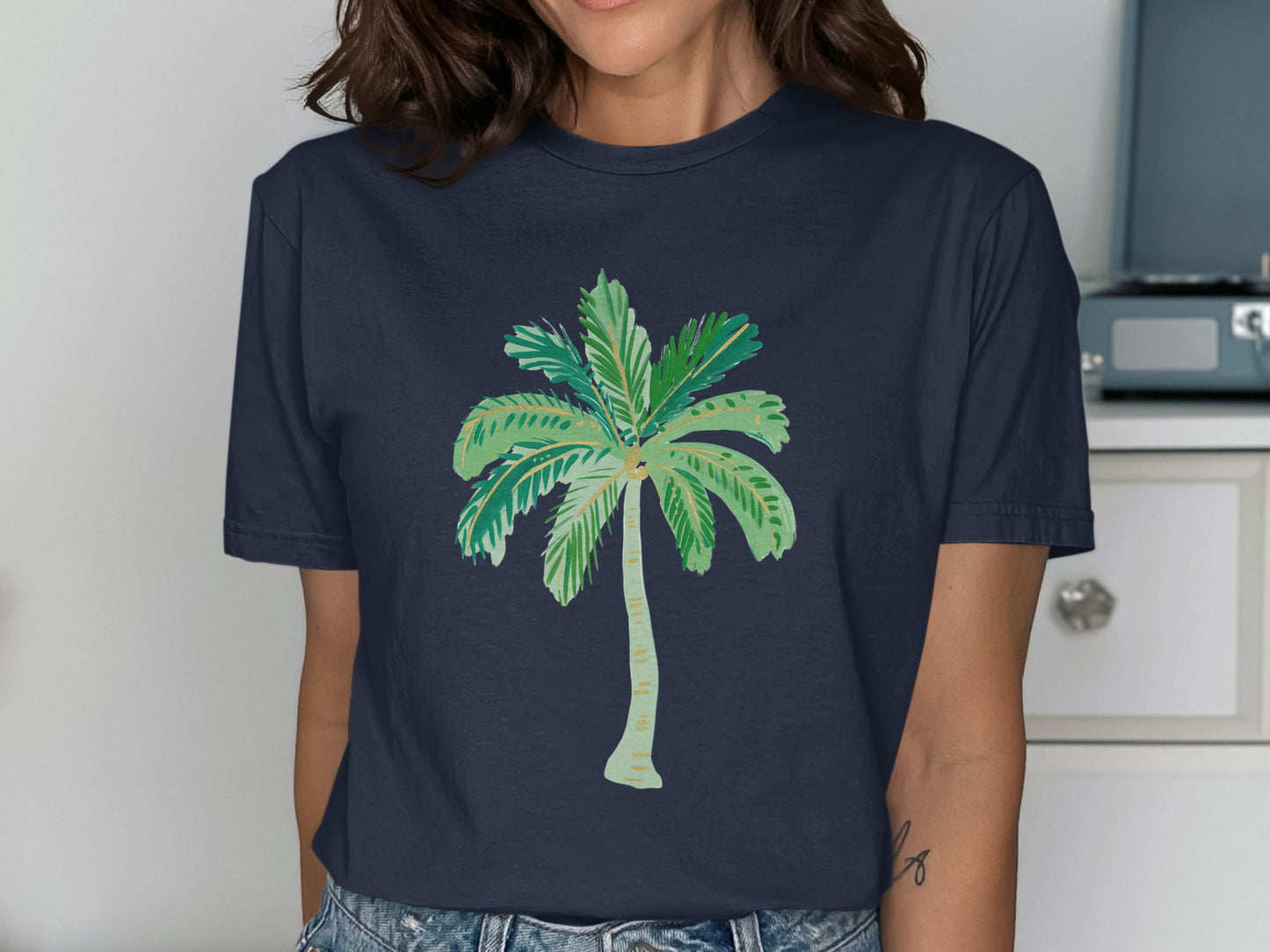 Navy t-shirt with a stylized green palm tree illustration.