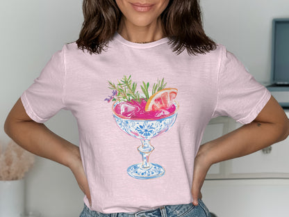 Pink t-shirt with a cocktail illustration in a decorative glass.