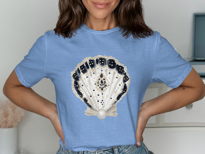 Light blue t-shirt with a decorative pearl seashell design.