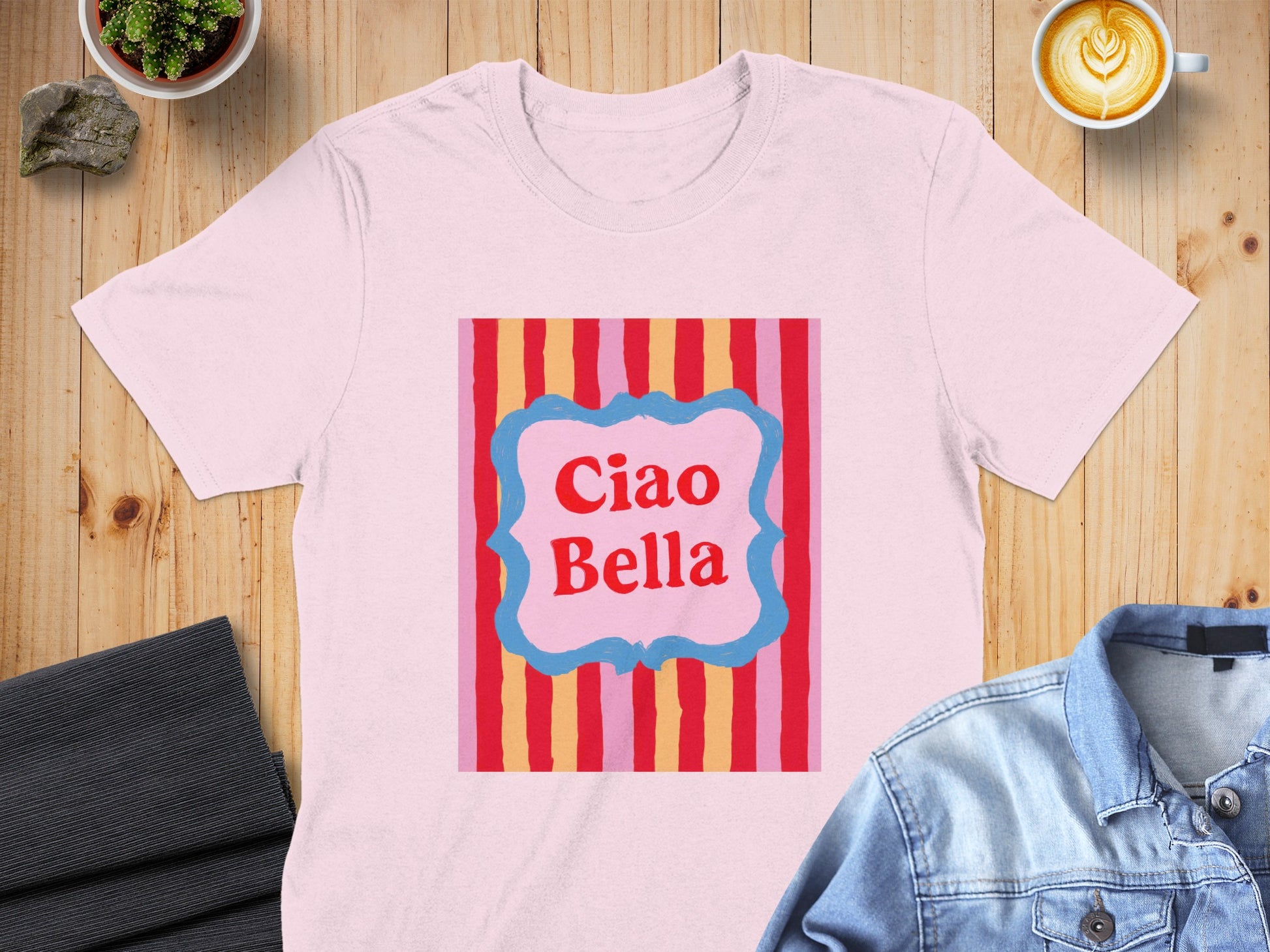 Pink t-shirt with "Ciao Bella" text on a colorful striped background.