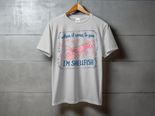 Gray t-shirt with pink lobster and hearts; "When it comes to you I'm Shellfish".