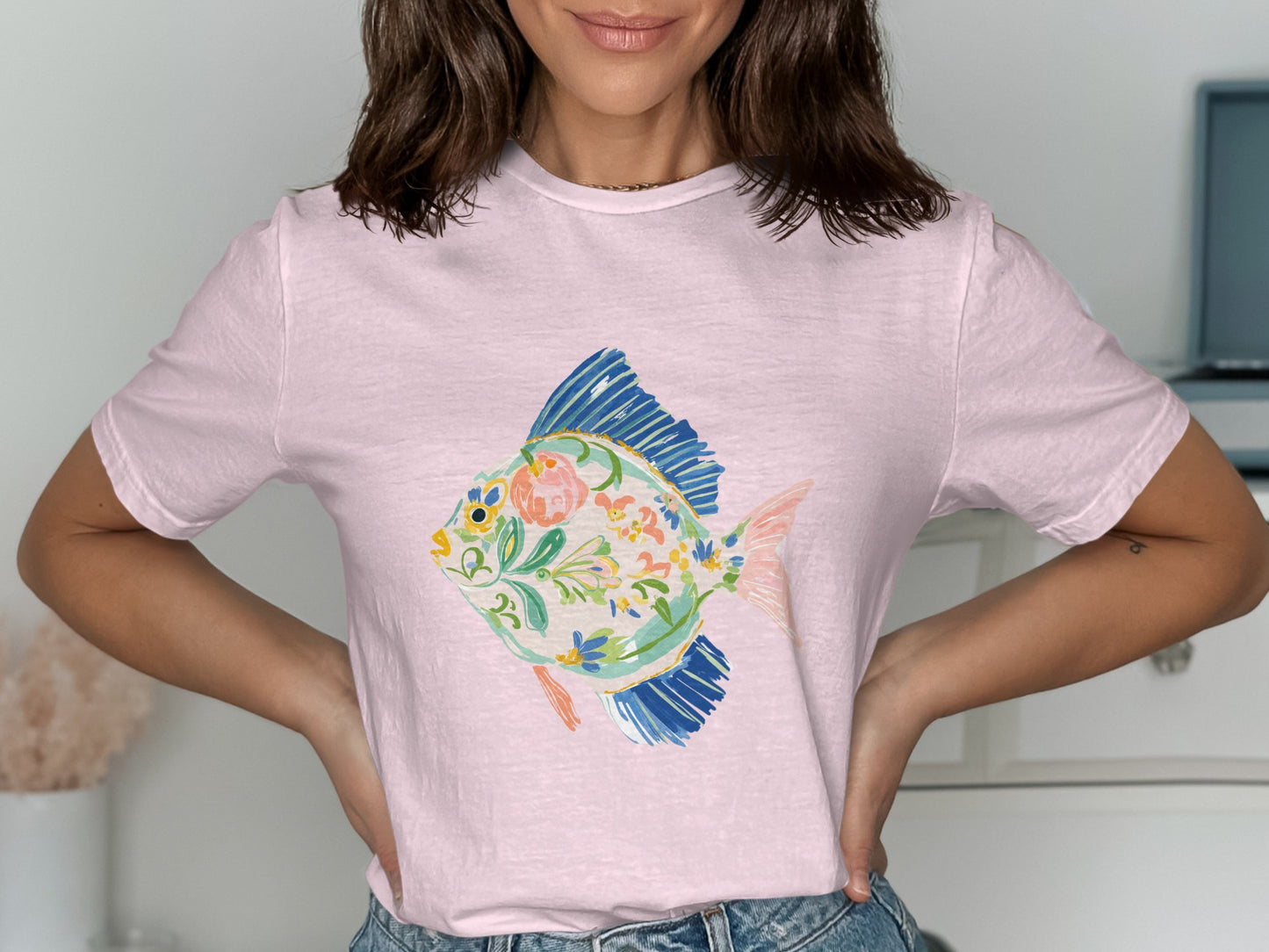 Pink t-shirt with a watercolor floral fish design.