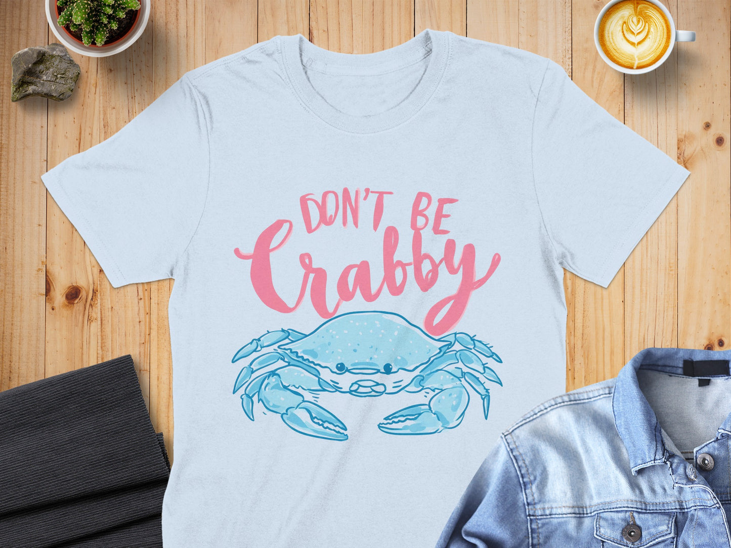 Light blue t-shirt with a pink crab and text that says "Don't Be Crabby".