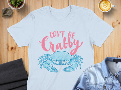 Light blue t-shirt with a pink crab and text that says "Don't Be Crabby".