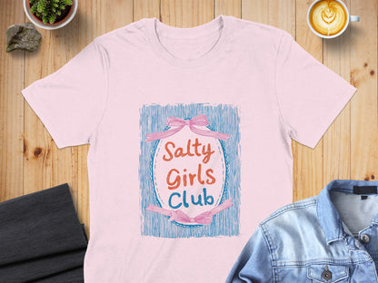 Pink t-shirt with "Salty Girls Club" text and blue ribbon design.