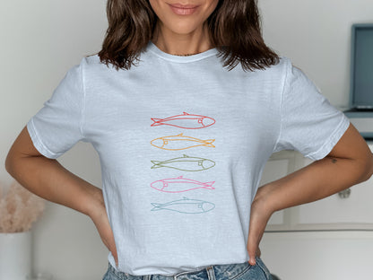 White t-shirt with four colorful, stylized fish illustrations in a row.