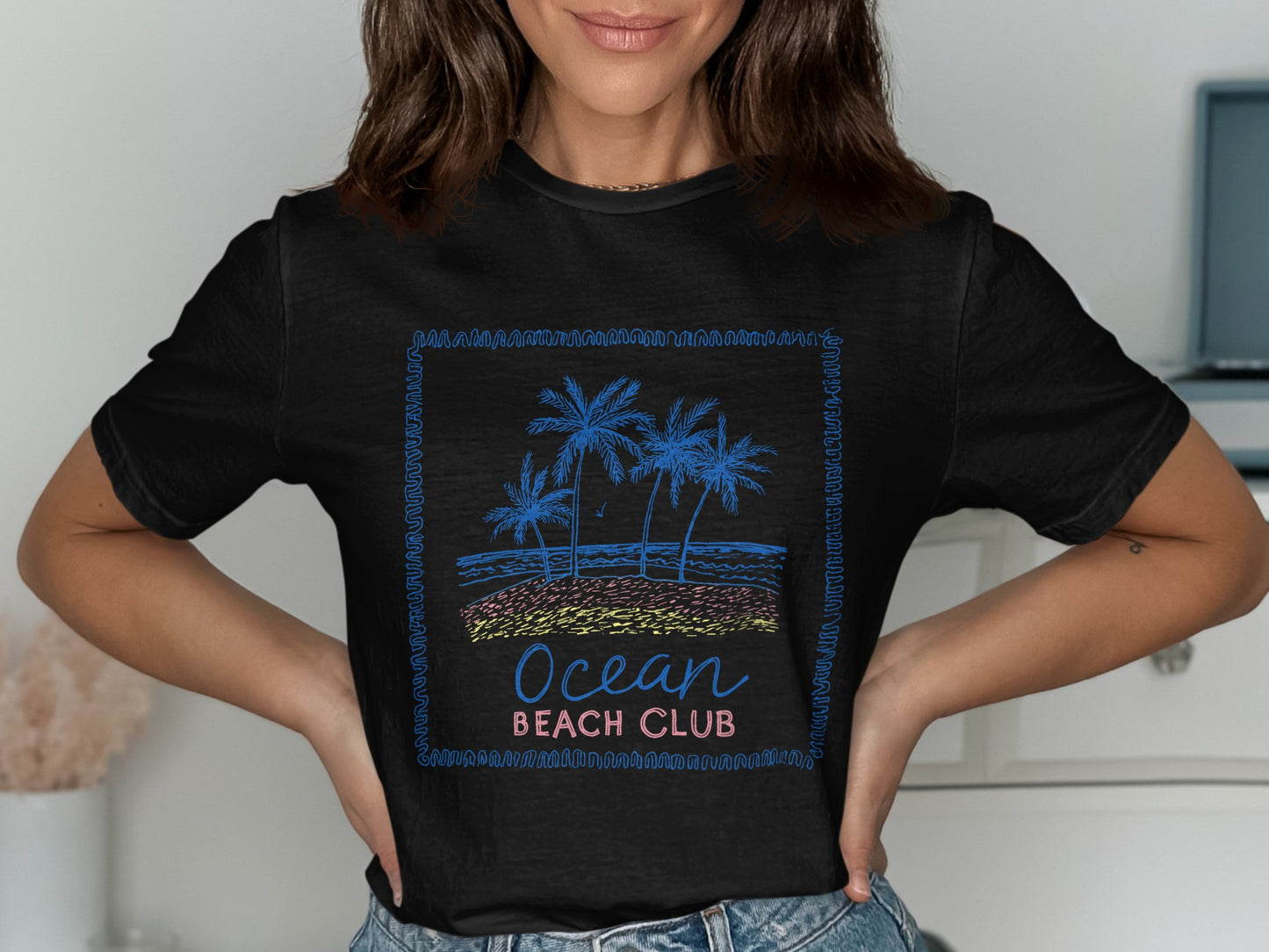 Black t-shirt with "Ocean Beach Club" and palm trees graphic.