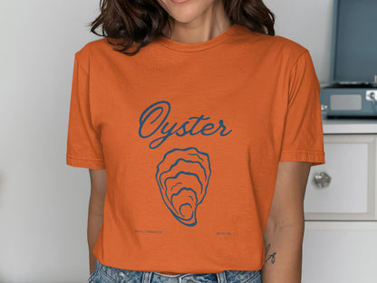 Orange t-shirt with blue "Oyster" graphic and small text "UNREALISTICATE" and "09/09/98".