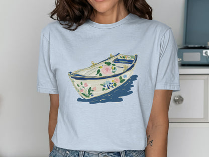 Light blue t-shirt featuring a white floral boat design with blue accents.