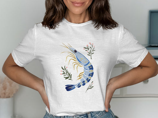 White t-shirt with a blue shrimp and pink floral illustration.