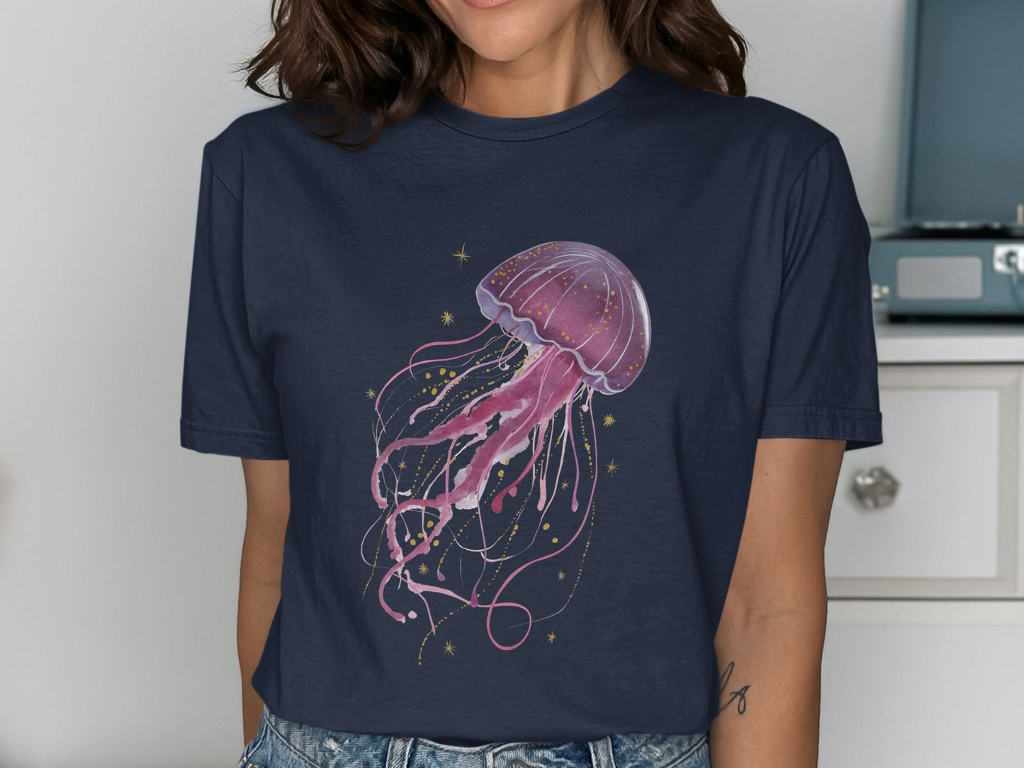 Navy t-shirt with a pink watercolor jellyfish and gold glitter design.