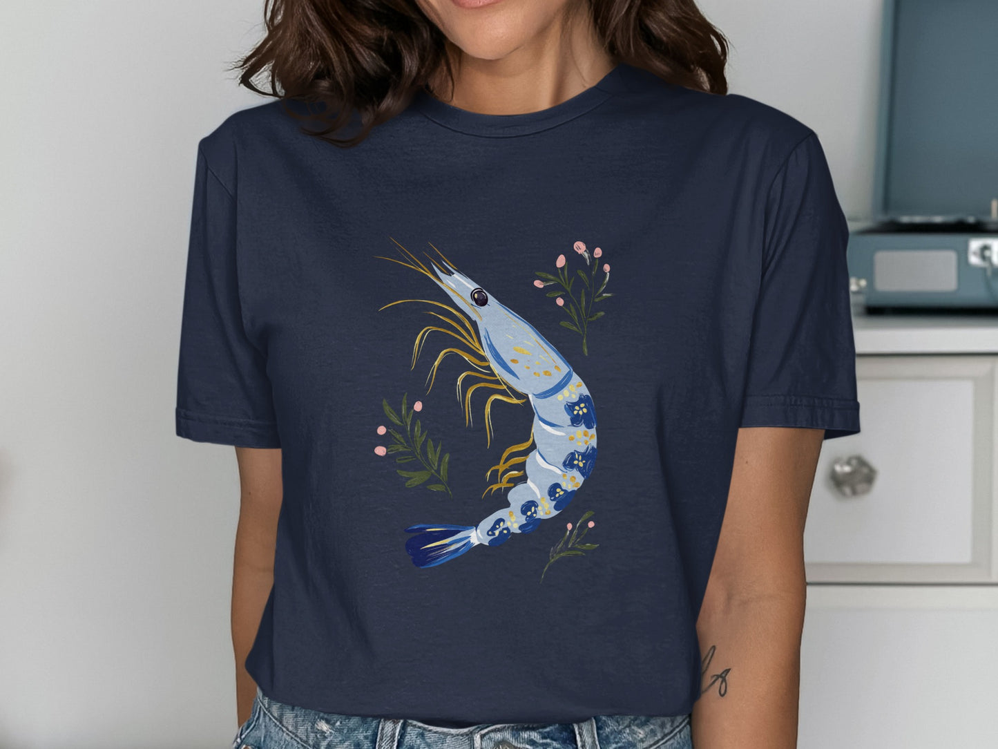 Navy t-shirt with a stylized shrimp and floral design.