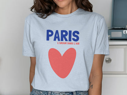 Light blue t-shirt with "PARIS L'AMOUR DANS L'AIR" and a red heart.