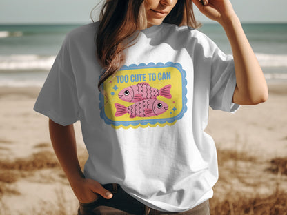White t-shirt with cartoon pink fish and text "TOO CUTE TO CAN".