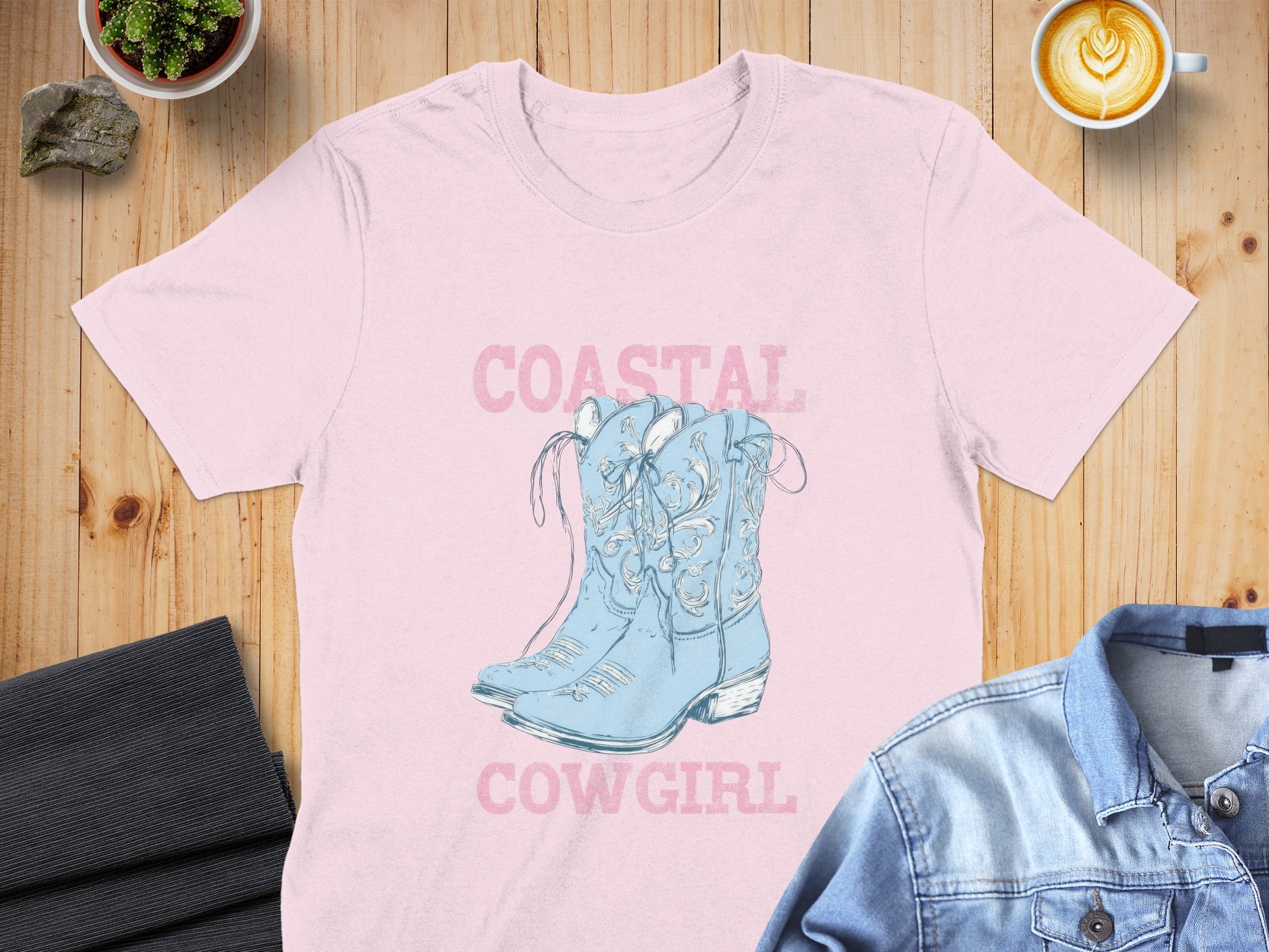 Light pink t-shirt with blue cowboy boots and "Coastal Cowgirl" text.