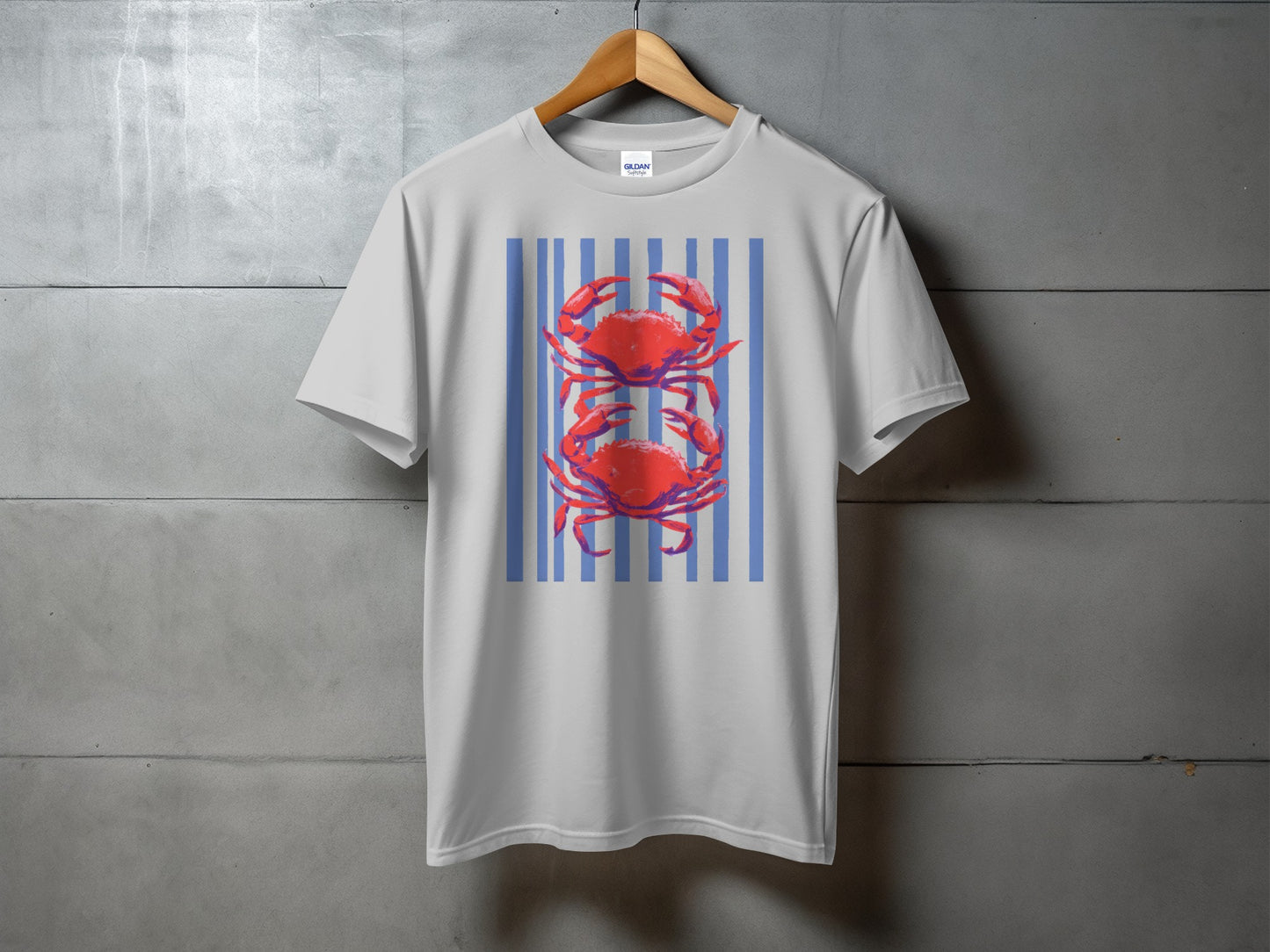 White t-shirt with two red crabs on a blue and white striped background.