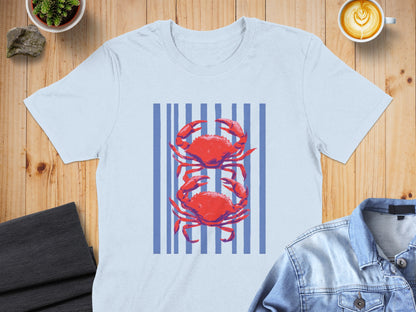 Light blue t-shirt with red crabs and blue stripes.