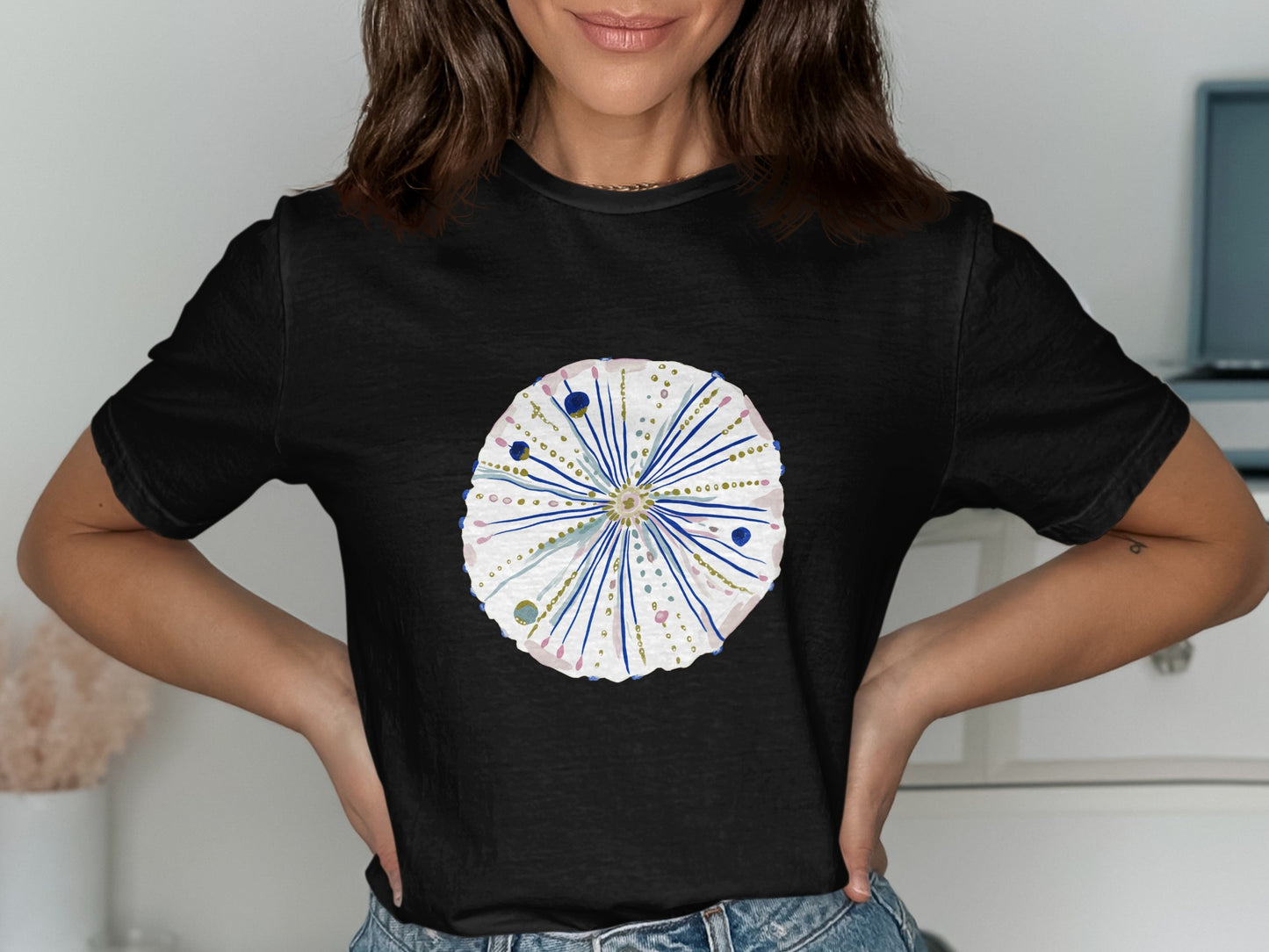 Black t-shirt with a detailed watercolor sea urchin design.