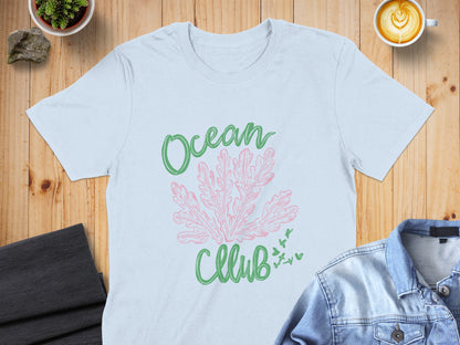 Light blue t-shirt with pink coral and green text "Ocean Club".