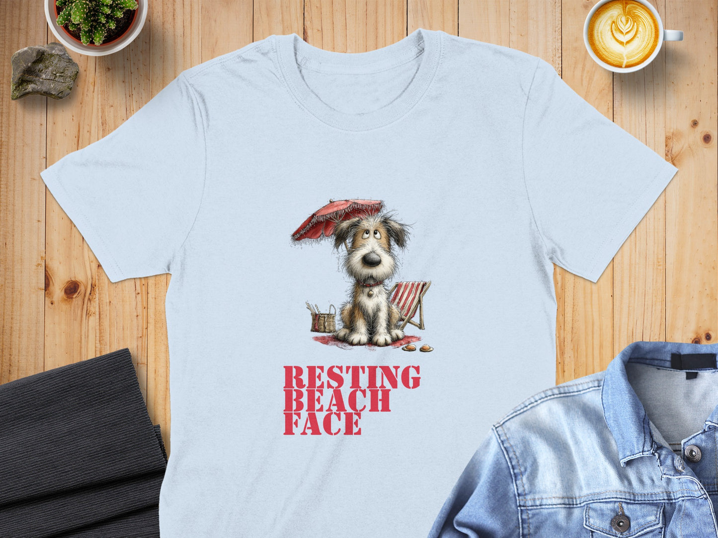 Light blue t-shirt with "RESTING BEACH FACE" text and cartoon dog under umbrella.
