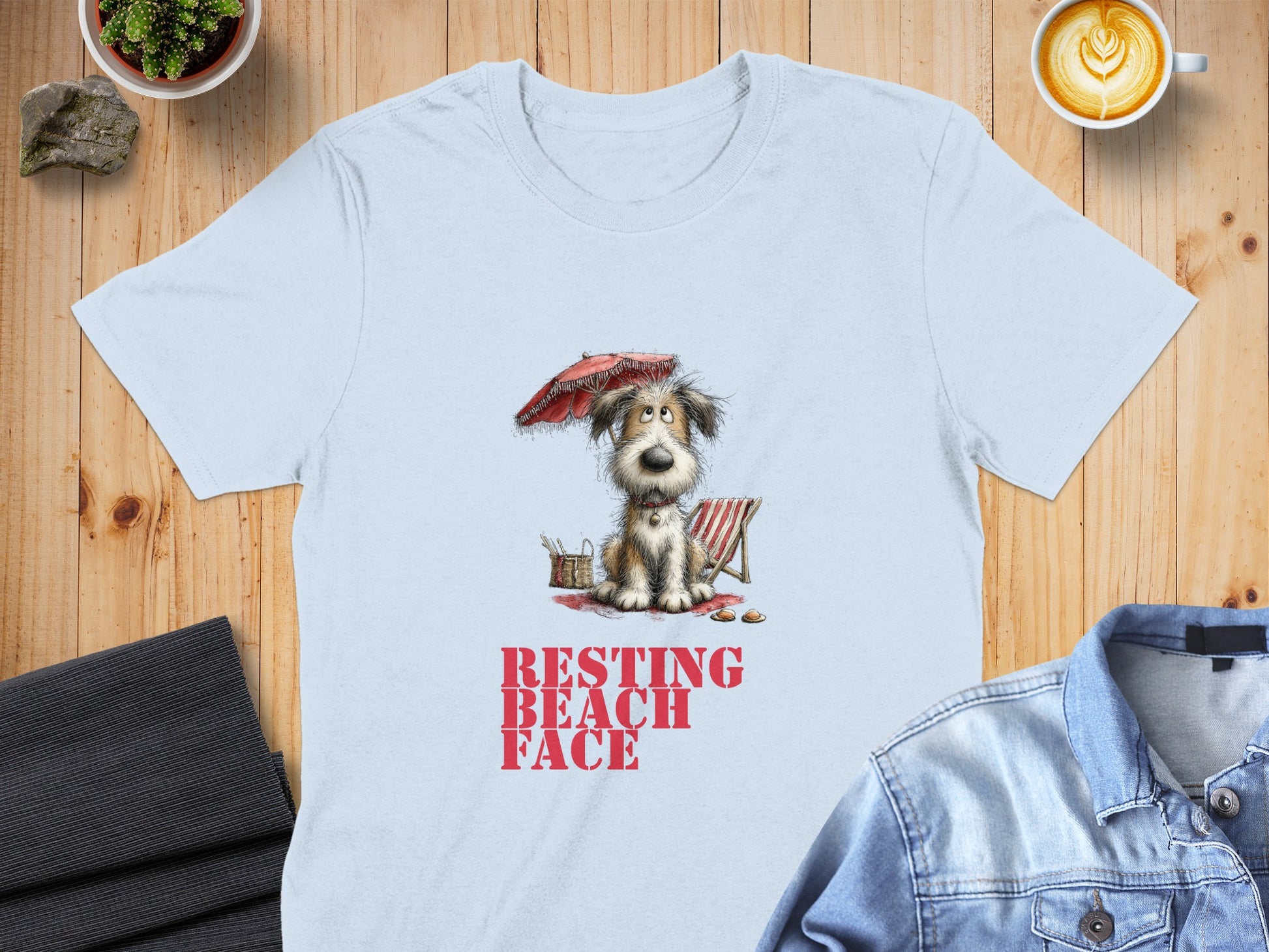 Light blue t-shirt with "RESTING BEACH FACE" text and cartoon dog under umbrella.