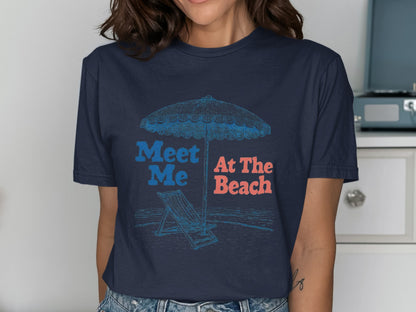Navy t-shirt with "Meet Me At The Beach" text and beach scene illustration.