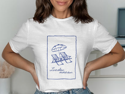 White t-shirt with blue line drawing of two beach chairs and umbrella, and text.