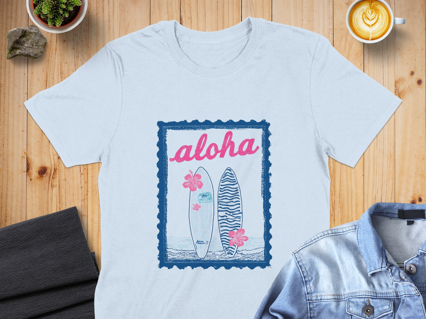 White t-shirt with "aloha" and two surfboards design.