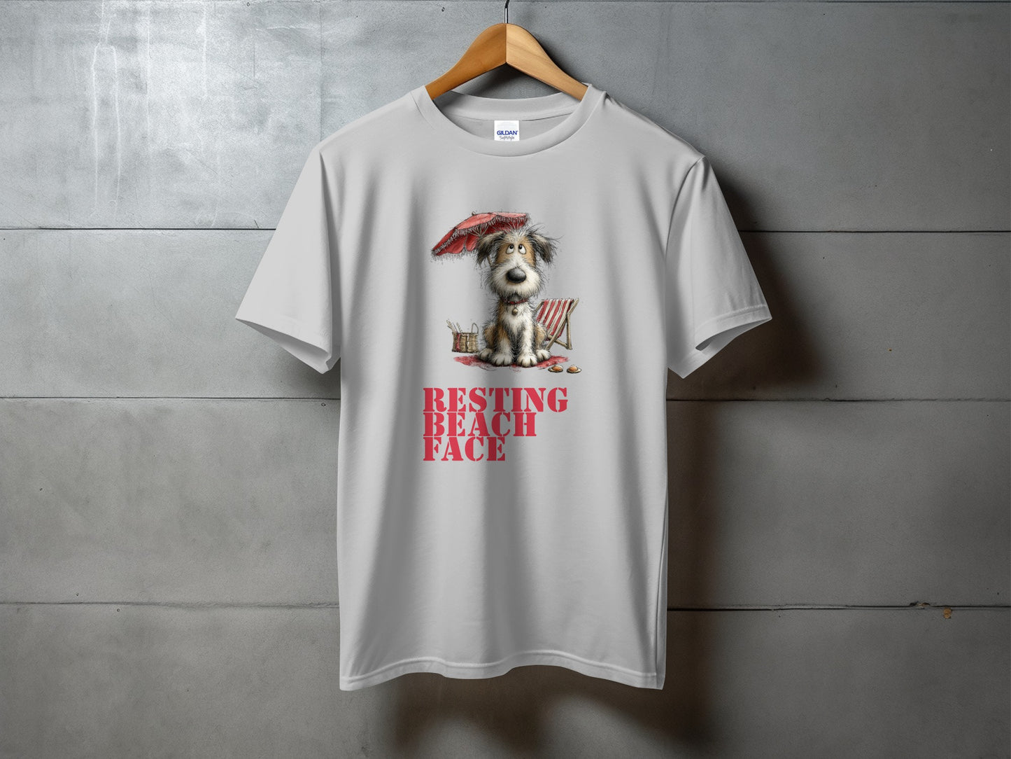 White t-shirt with cartoon dog, beach chair, umbrella, and text "RESTING BEACH FACE".