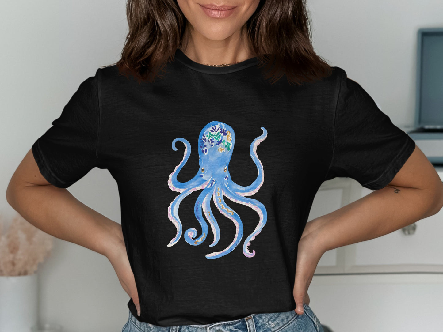 Black t-shirt with a blue watercolor octopus design adorned with floral patterns.