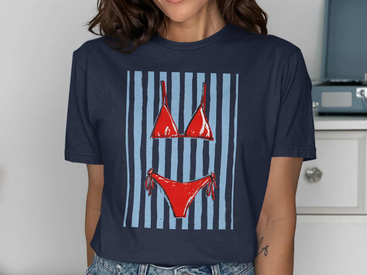 Navy t-shirt featuring a red bikini design with blue and light blue stripes.