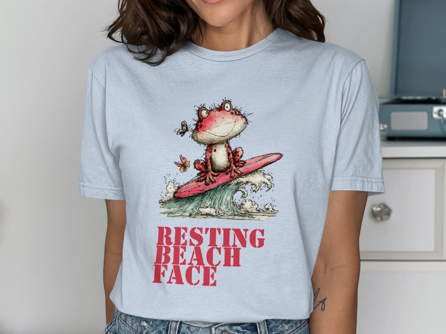 Frog on surfboard riding a wave with text "RESTING BEACH FACE".