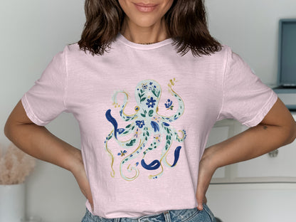 Light pink t-shirt with a blue and gold floral octopus graphic.