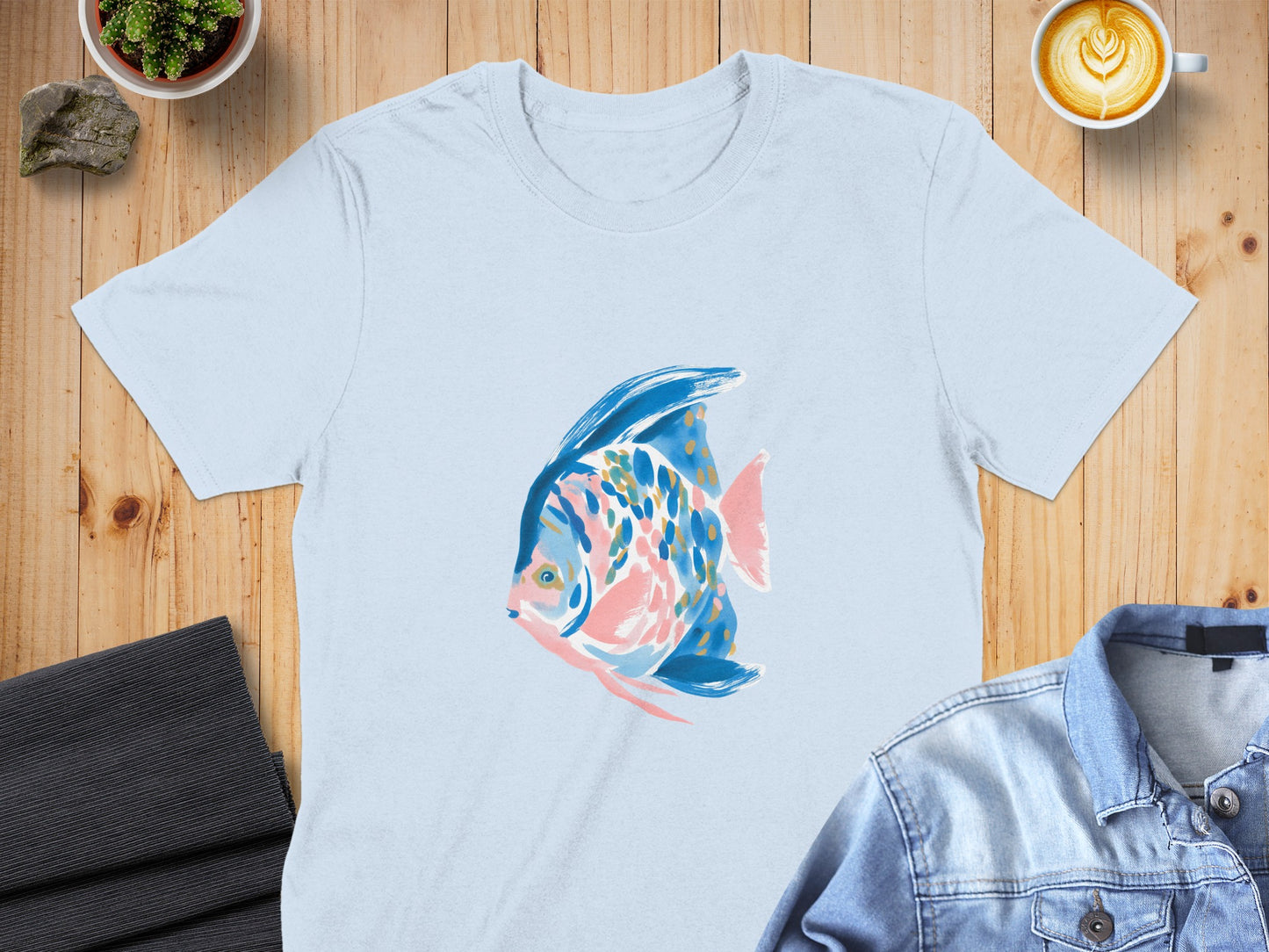 Light blue t-shirt with colorful abstract fish graphic.