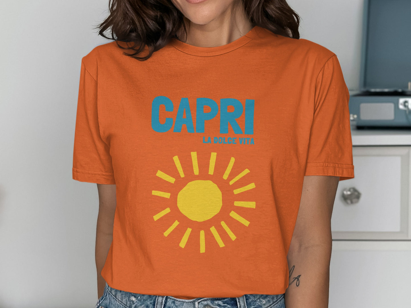 Orange t-shirt with "CAPRI LA DOLCE VITA" and a yellow sun graphic.