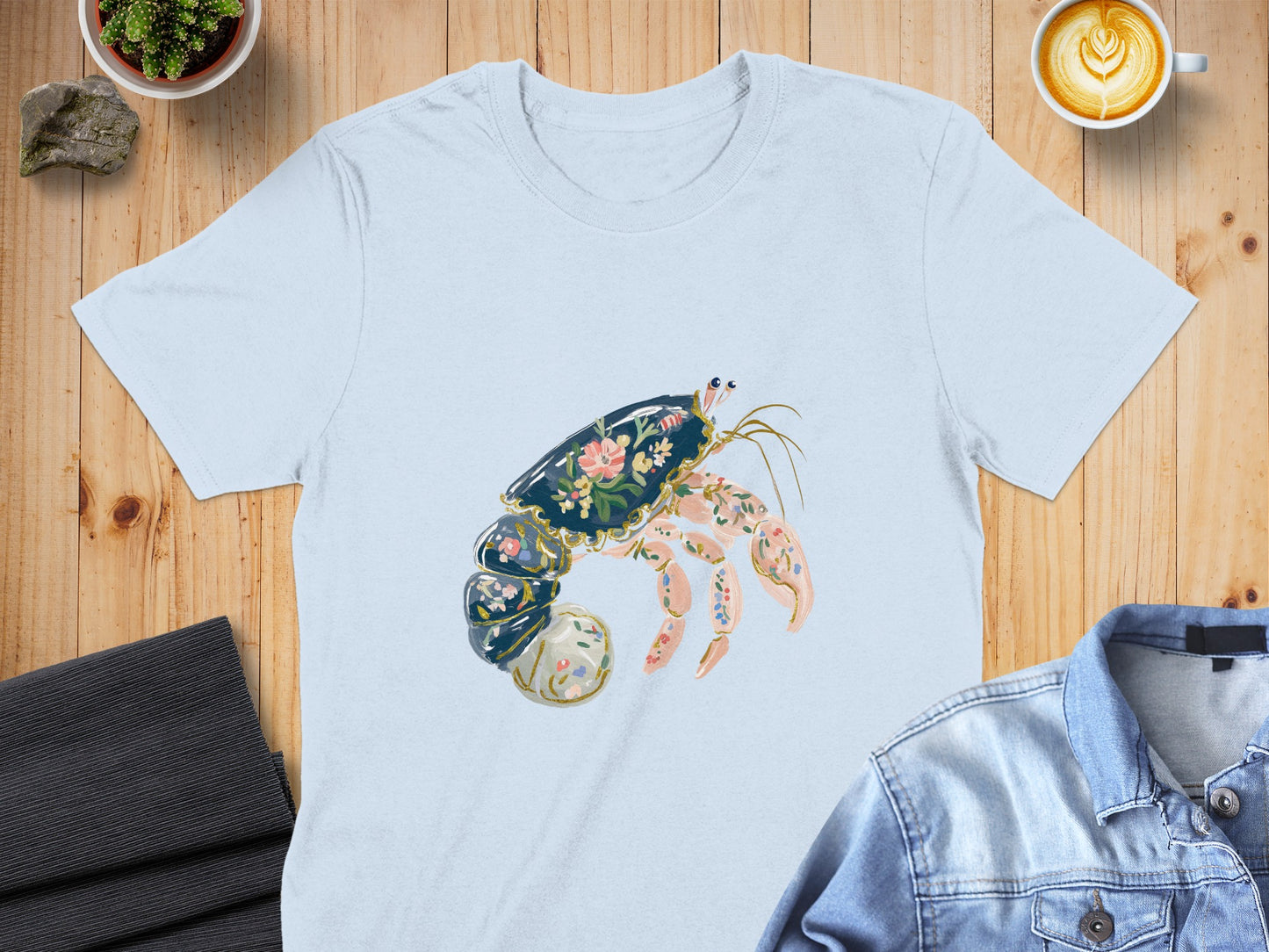 Light blue t-shirt with a floral-patterned hermit crab design.